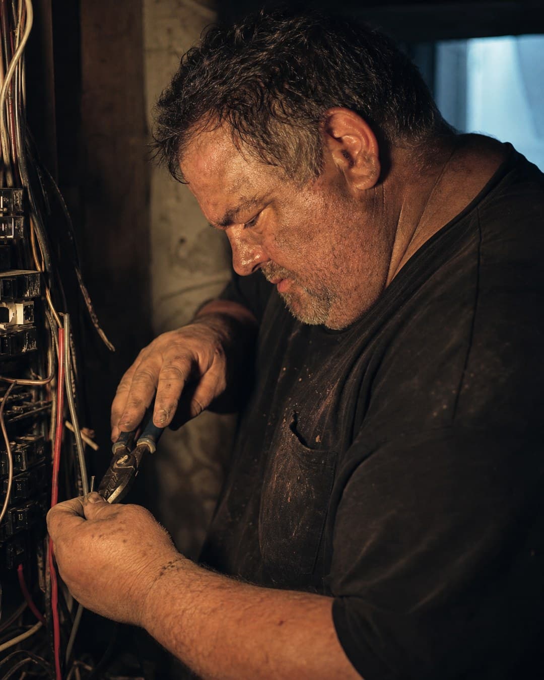 An electrician working in a panel